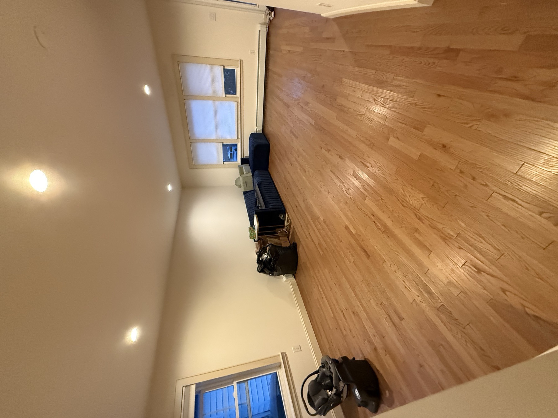 Clean family room with polished hardwood floor after Queens move-in cleaning