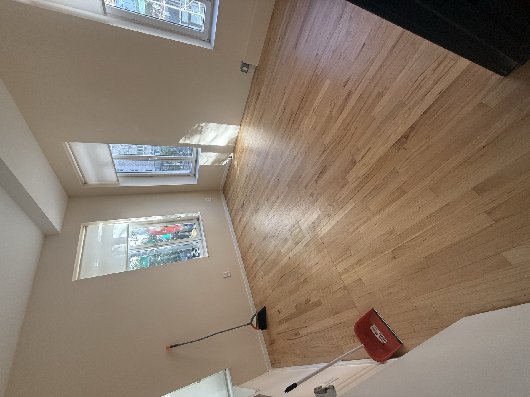 Clean empty room and hardwood floors after tenant turnover cleaning in New York City