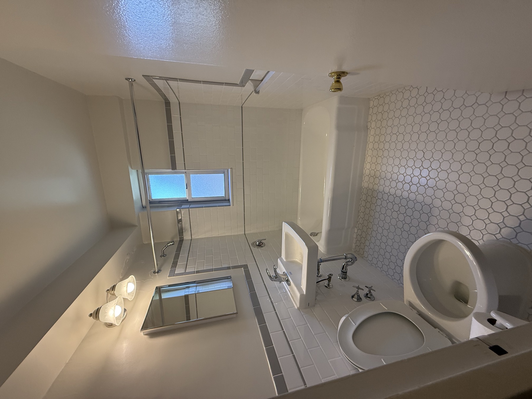 Clean bathtub, sink, toilet, and tile floor after Manhattan move-in cleaning