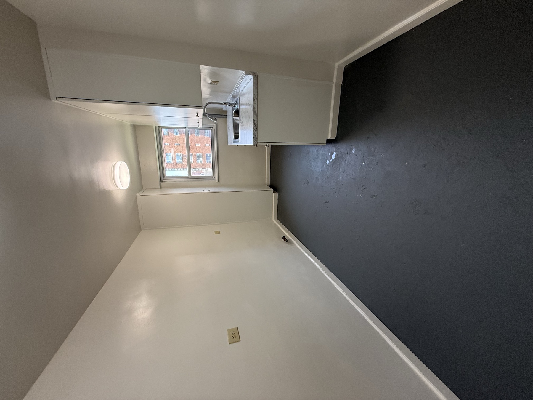Clean kitchen floor, sink, cabinets, and surfaces after Manhattan move-in cleaning