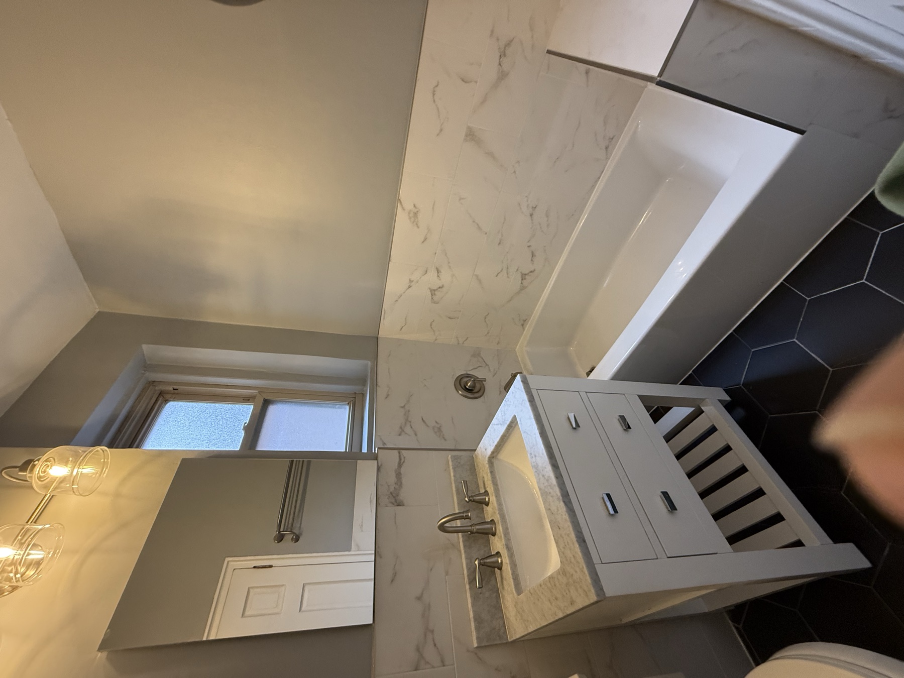Clean bathtub, vanity, and bathroom surfaces after move-in cleaning in New York City
