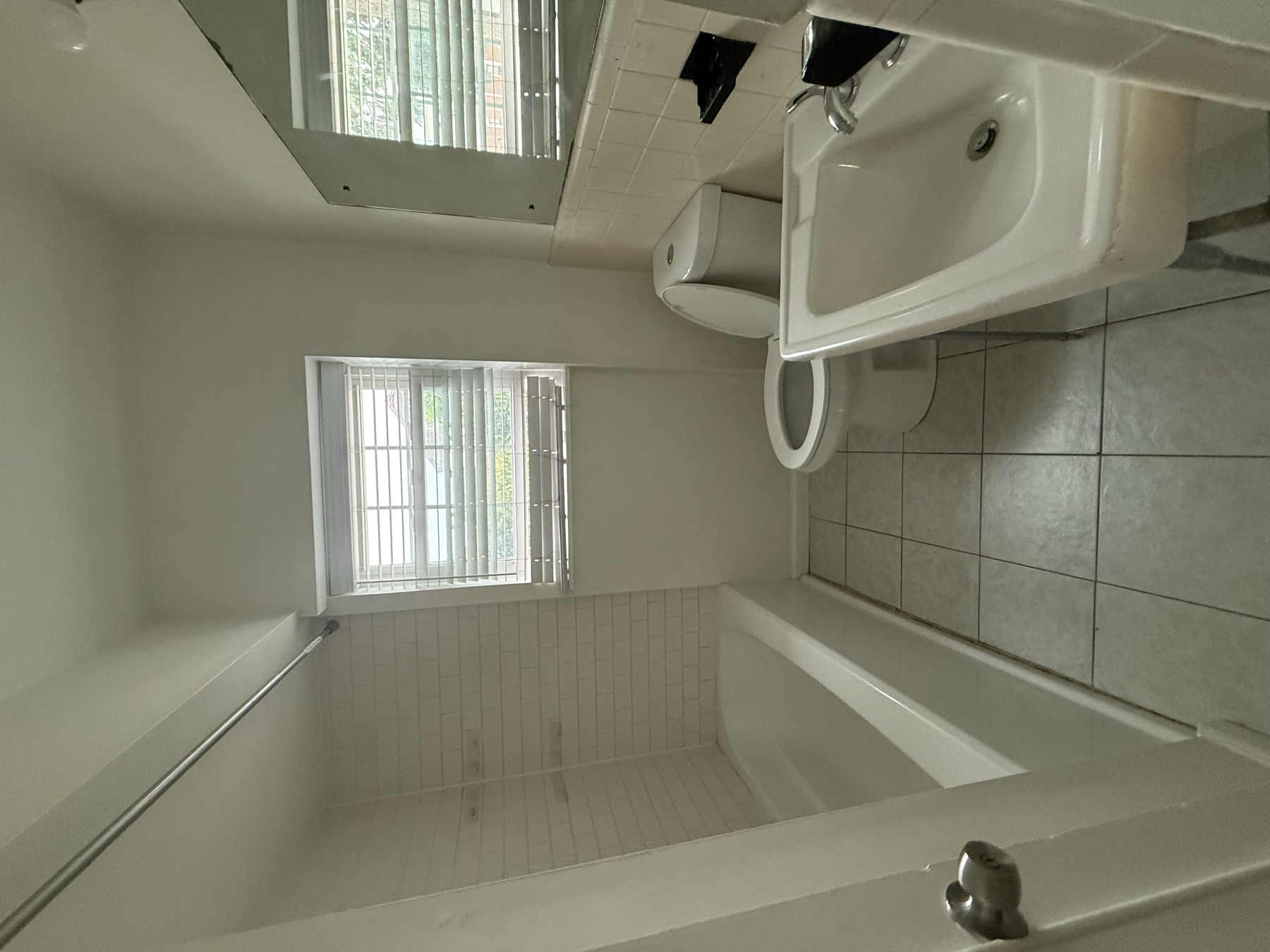 Clean bathtub, vanity, toilet, and tile after cleaning a newly purchased home