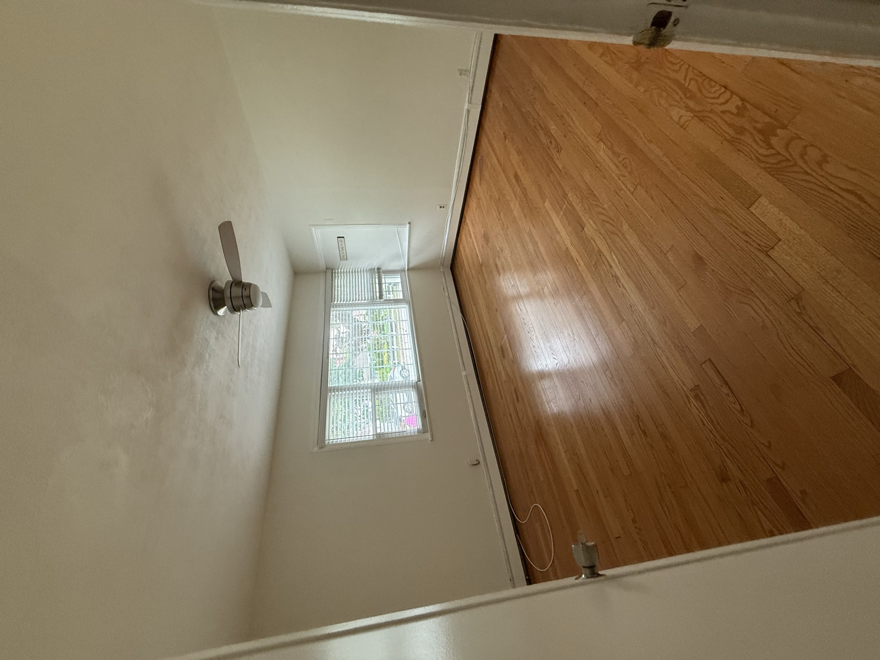 Clean empty bedroom with polished hardwood floor after move-in home cleaning in New York City