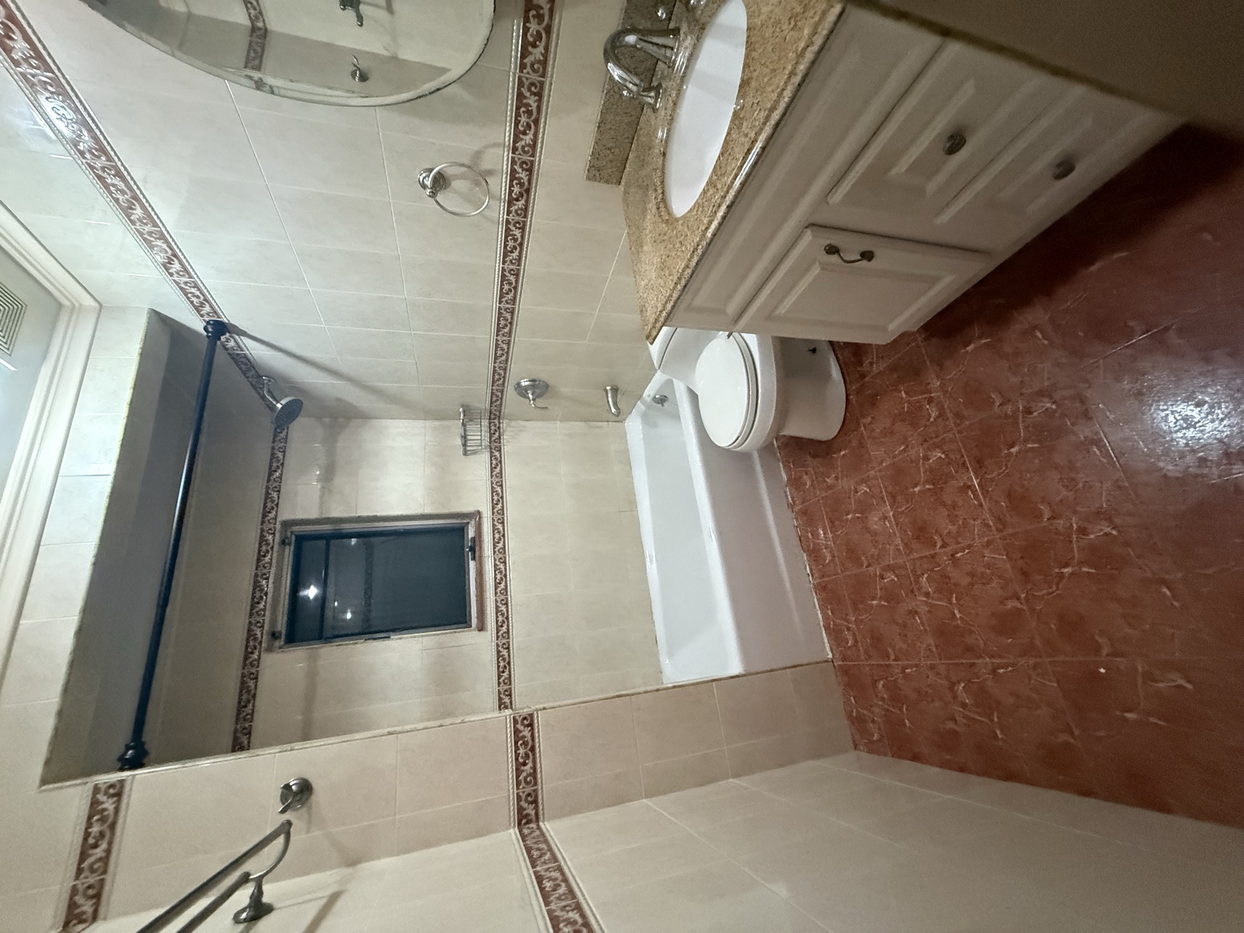 Clean bathroom with tub, vanity, toilet, and tile after move-out cleaning