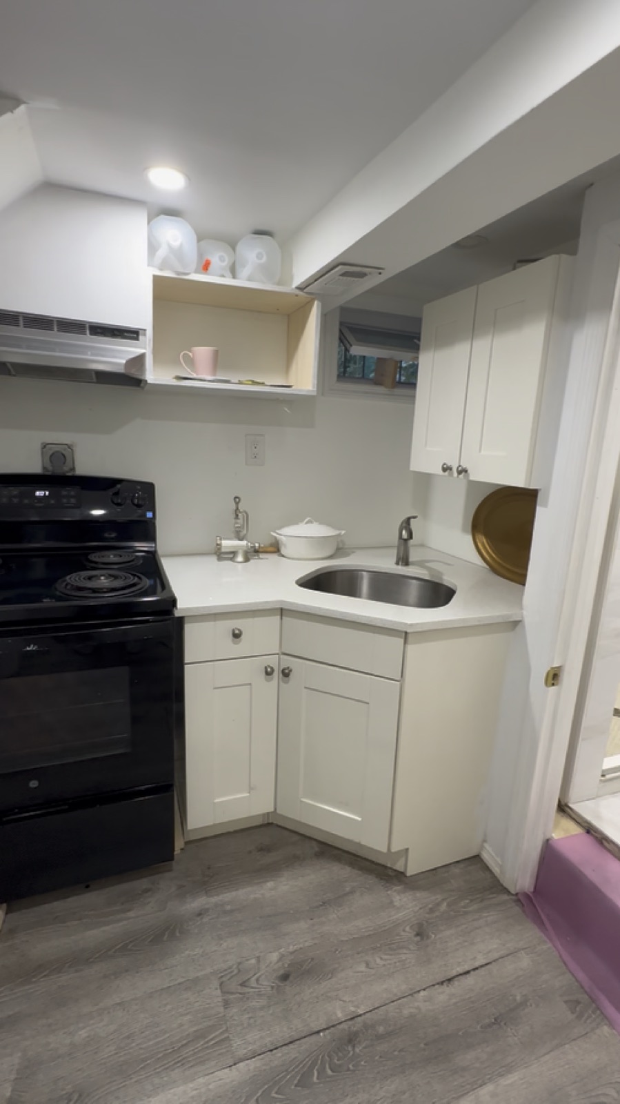 Clean kitchen, cabinets, sink, stove, and floor after Queens move-out cleaning