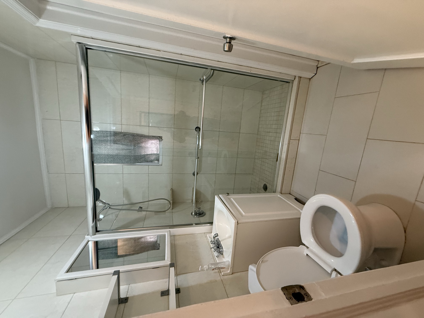 Clean bathroom and glass shower after move-in apartment cleaning in Queens, New York